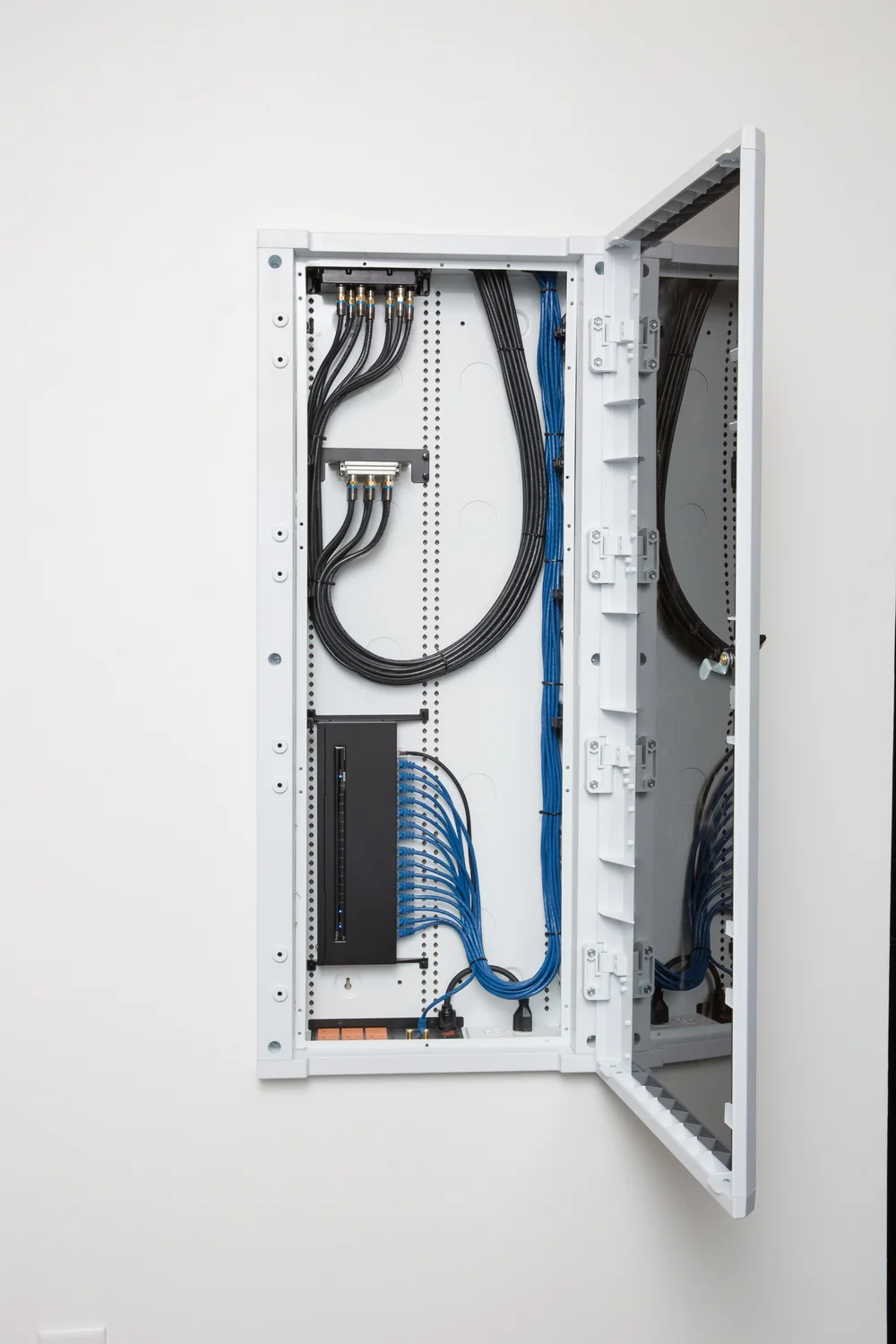 A clean structured wiring cabinet with neatly routed network cabling